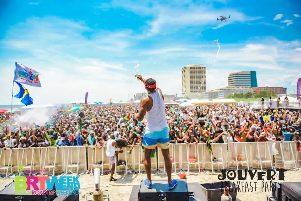 Performer leading a packed BRT Weekend beach crowd